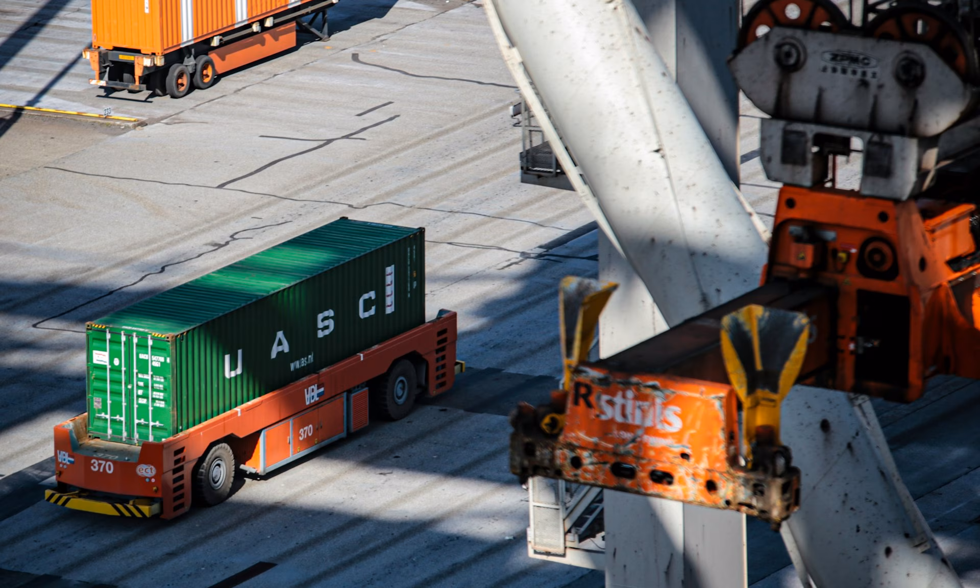 Cargo trucks and a gantry crane operating at a container terminal